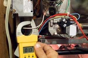 Person testing furnace. All Seasons Heating & Cooling, Inc provides furnace repair services in Vancouver WA and Camas WA.