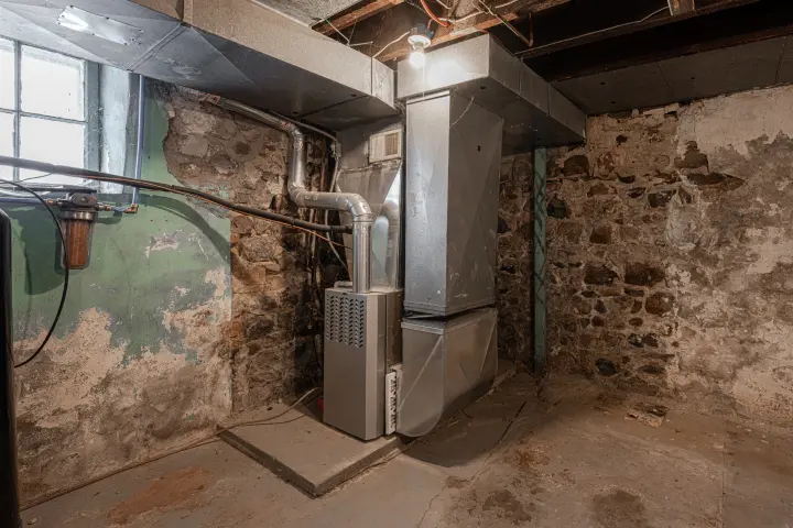 A new furnace installed in an old home’s basement. Installing a new furnace with All Seasons HVAC can save you time and money.