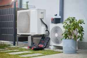 A mini split system outside with HVAC technician equipment attached for an inspection